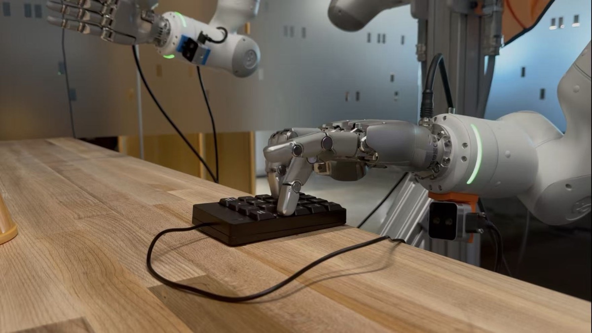 SEAR robotic hand pressing a keypad on a lab workbench; video pending
